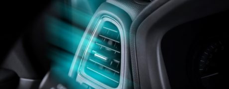 A close-up view of an air conditioner vent inside a car.