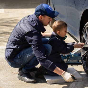 A father and son do car repair and maintenance