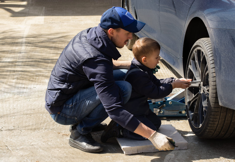 A father and son do car repair and maintenance