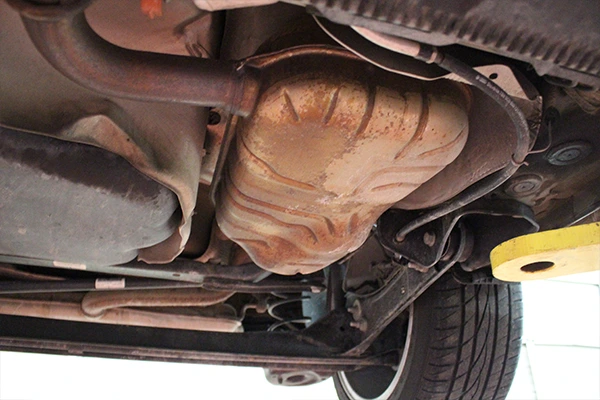 Muffler beneath vehicle on lift