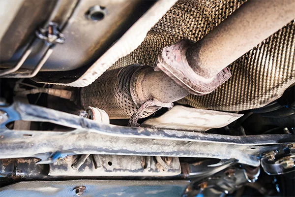 Rusted catalytic converter on underside of vehicle