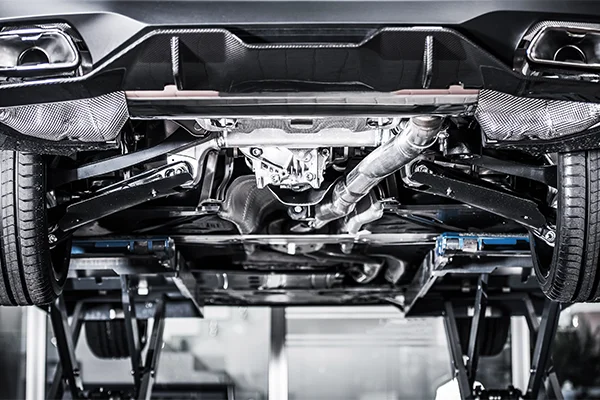 Car on lift showing underside and suspension system