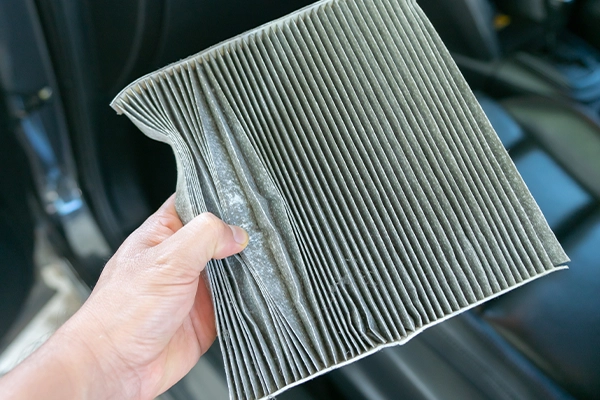 Dirty and crumpled cabin air filter removed from vehicle